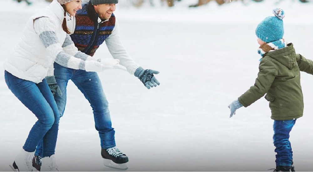 Parents teaching son to ice skate